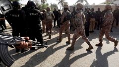 Image: Paramilitary soldiers walk after an attack on the Chinese consulate,