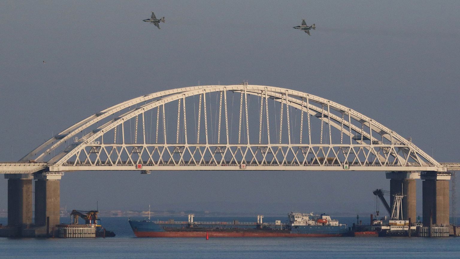 Image: Russian jet fighters fly over a bridge connecting the Russian mainla
