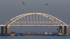 Image: Russian jet fighters fly over a bridge connecting the Russian mainla
