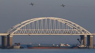 Image: Russian jet fighters fly over a bridge connecting the Russian mainla