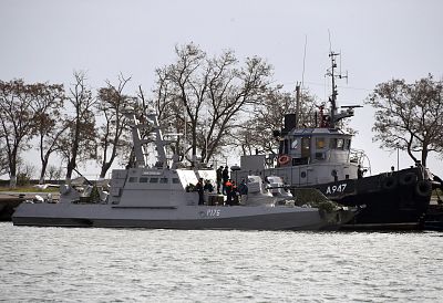 Two Ukrainian warships and a Ukrainian tugboat sit in a port in the Crimean city of Kerch after they were captured by the Russian Border Guard Service and escorted there on Nov. 26, 2018.