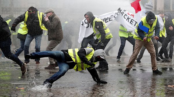Image: Protesters wearing fluorescent yellow vests during clashes in Paris Image: Protesters wearing fluorescent yellow vests during clashes in Paris