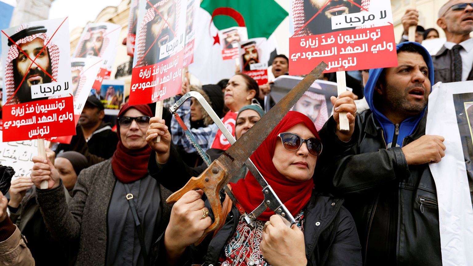 Image: Woman takes part in a protest, opposing the visit of Saudi Arabia's 