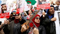 Image: Woman takes part in a protest, opposing the visit of Saudi Arabia's 