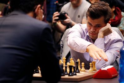 Magnus Carlsen hits the clock as he plays against Fabiana Caruana in the 2018 World Chess Championship in London on Nov. 28, 2018.
