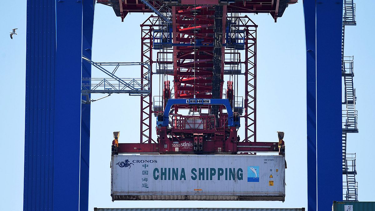 Image: A China Shipping container is loaded at a terminal in the port of Ha