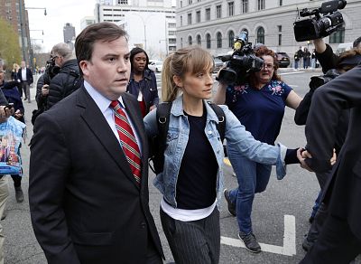 Allison Mack is escorted away from federal court in Brooklyn on Tuesday.
