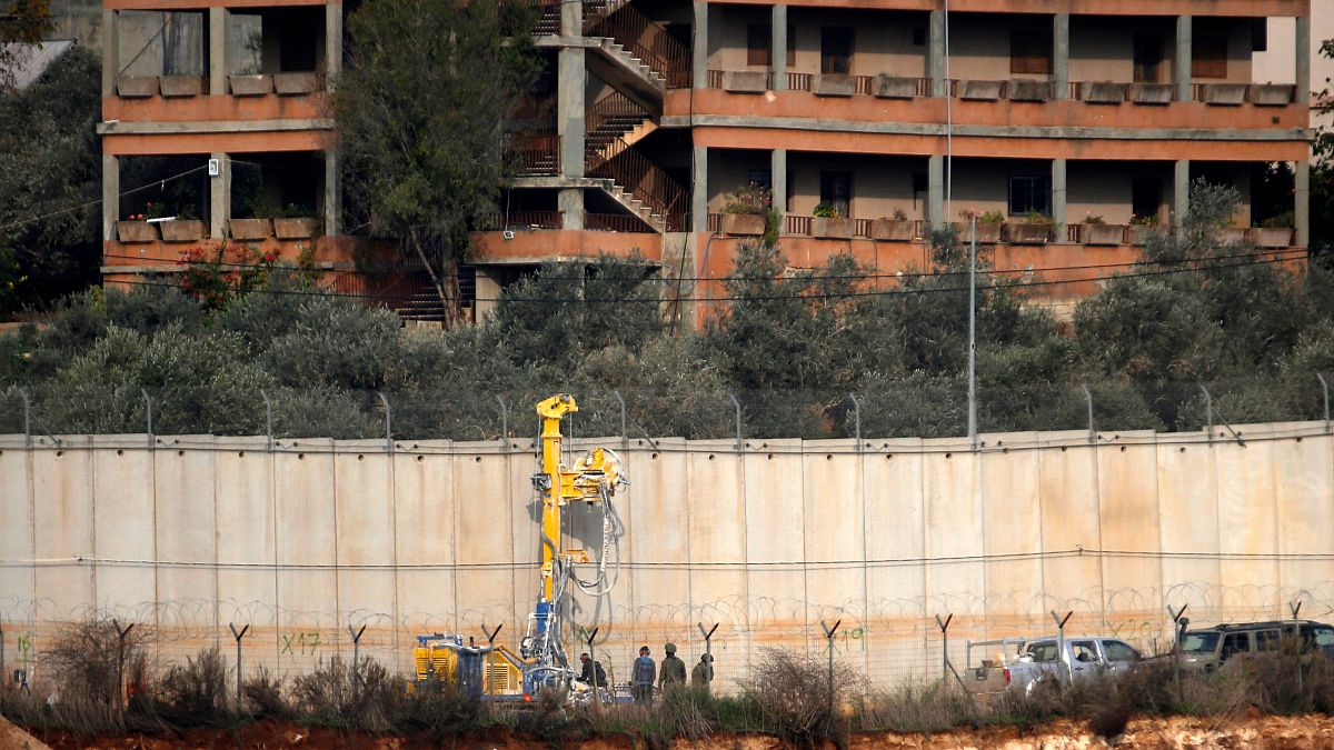 Image: Israeli soldiers standing by machinery near the border wall with Leb