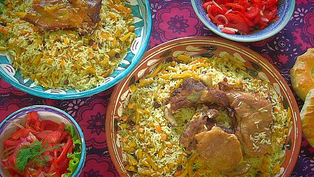 Enjoying a traditional Uzbek dish called plov
