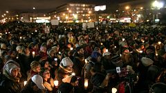 Mourners gather at a vigil for victims of shooting at a mosque that killed 