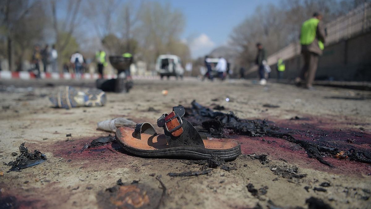 Image: A sandal lies on the ground after a suicide bombing near Kabul Unive