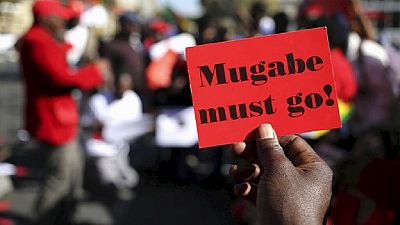 Student arrested over 'step down Mugabe' placard at graduation ceremony