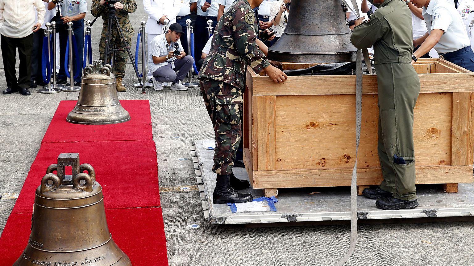 Image: Philippine military personnel unload the three church bells