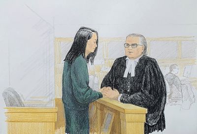 Meng Wanzhou, Huawei\'s chief financial officer, speaks with lawyer David Martin in court in Vancouver, British Columbia, on Dec. 10, 2018. Meng faces extradition to the U.S. on charges of trying to evade U.S. sanctions on Iran.