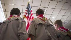 Image: Boy Scouts stand on stage with a U.S. flag during the Pledge of Alle