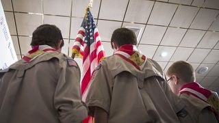 Image: Boy Scouts stand on stage with a U.S. flag during the Pledge of Alle