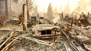 The remains of a burned vehicle outside of a home in Paradise, California.