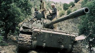 Image: Mujahedeen sit on a captured Soviet tank in Afghanistan in 1987.