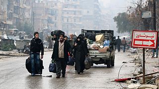 Thousands stream out of Aleppo as rebel deal is struck