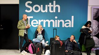 Passengers wait for information on delayed flights at Gatwick Airport on Th