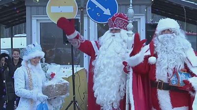 Finnish, Russian Santas exchange gifts at border