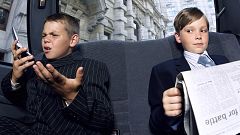 Boys dressed as businessmen in back of a car.