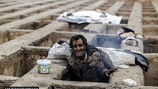 In pictures: homeless Iranians find shelter from cold in empty graves