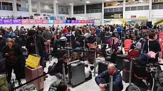 Image:Travelers wait in Gatwick Airport after it was shut down by authoriti