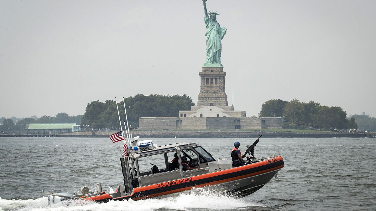 Image: A U.S. Coast Guard boat passes Liberty Island in New York Harbor on 