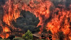 Image: Firefighters try to extinguish flames in the village of Kineta, Gree