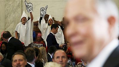 US lawmakers heckled by protesters adorned in KKK outfits