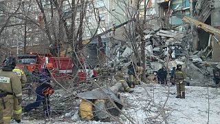 Image: Emergency personnel work at the site of collapsed apartment building