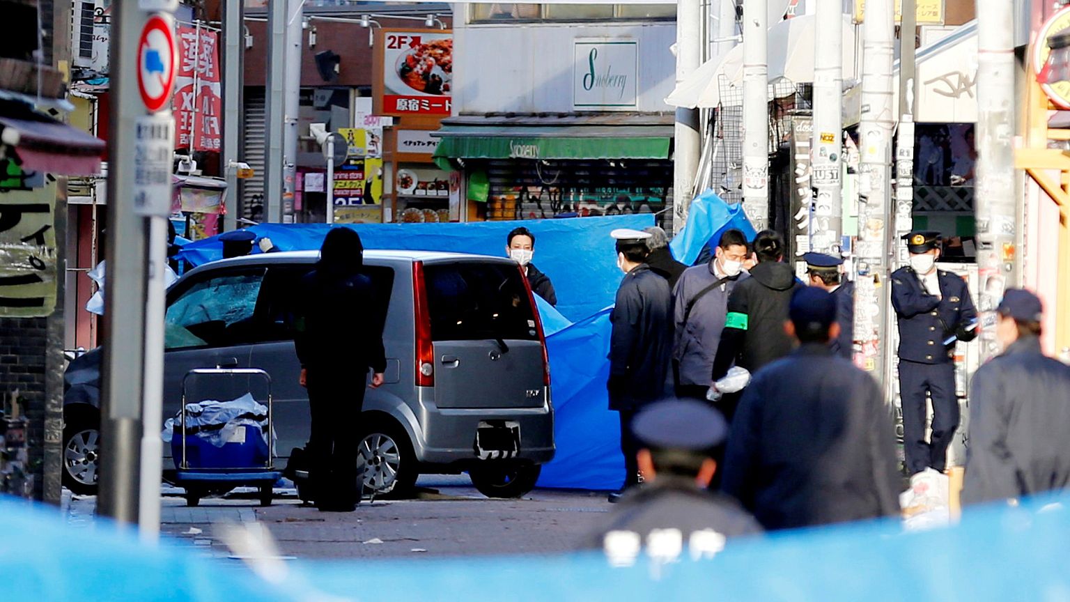 Image: Policemen stand next to a car which plowed into pedestrians on New Y