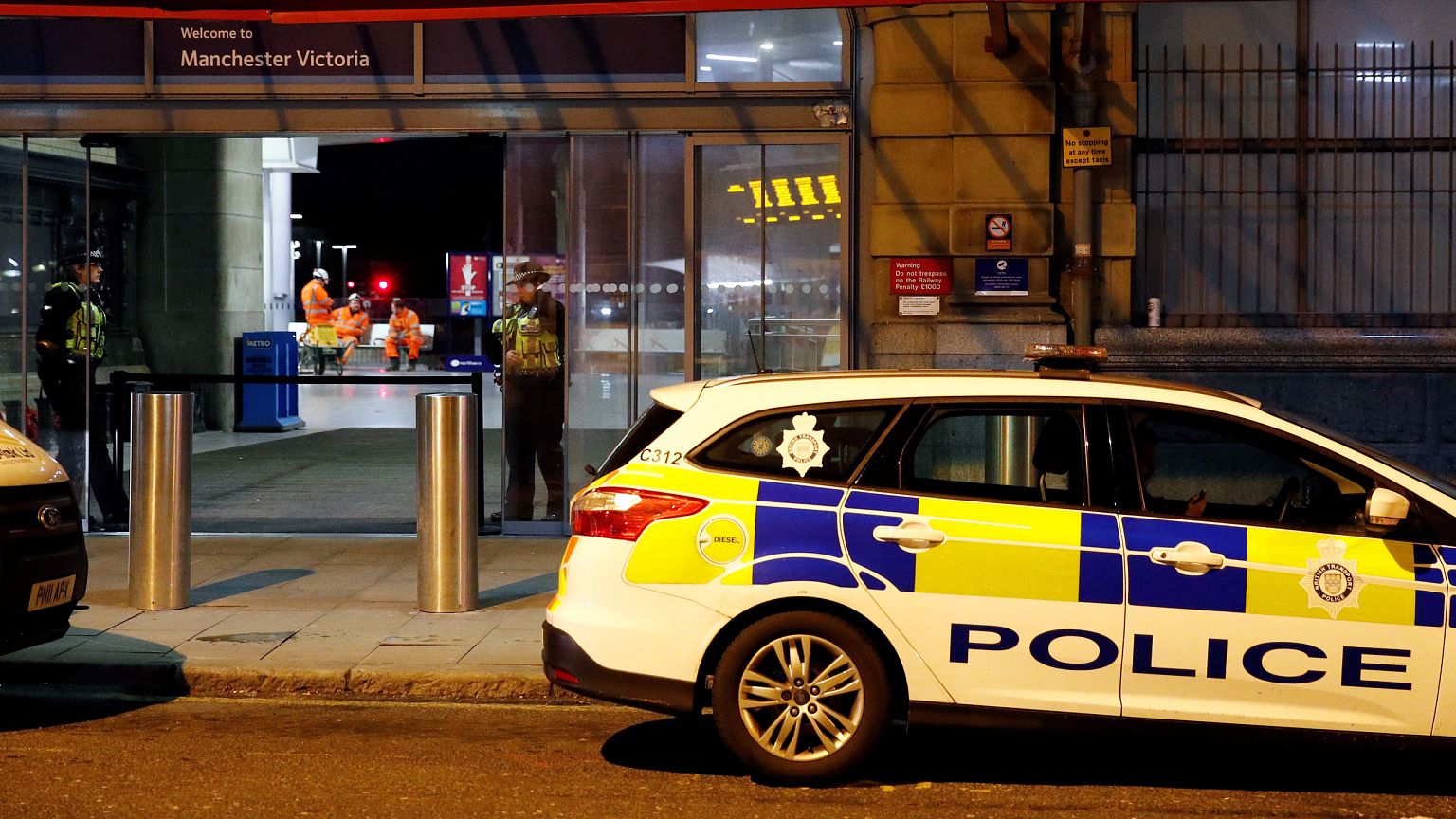Image: Police officers stand at the end of a tram platform following a stab