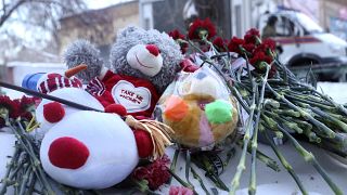 Image: Toys and flowers left at the scene in Magnitogorsk, Russia.