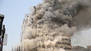 High-rise horror as Tehran building collapses killing dozens of firefighters