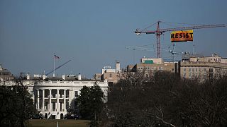 Greenpeace take over crane near White House to display "Resist" message
