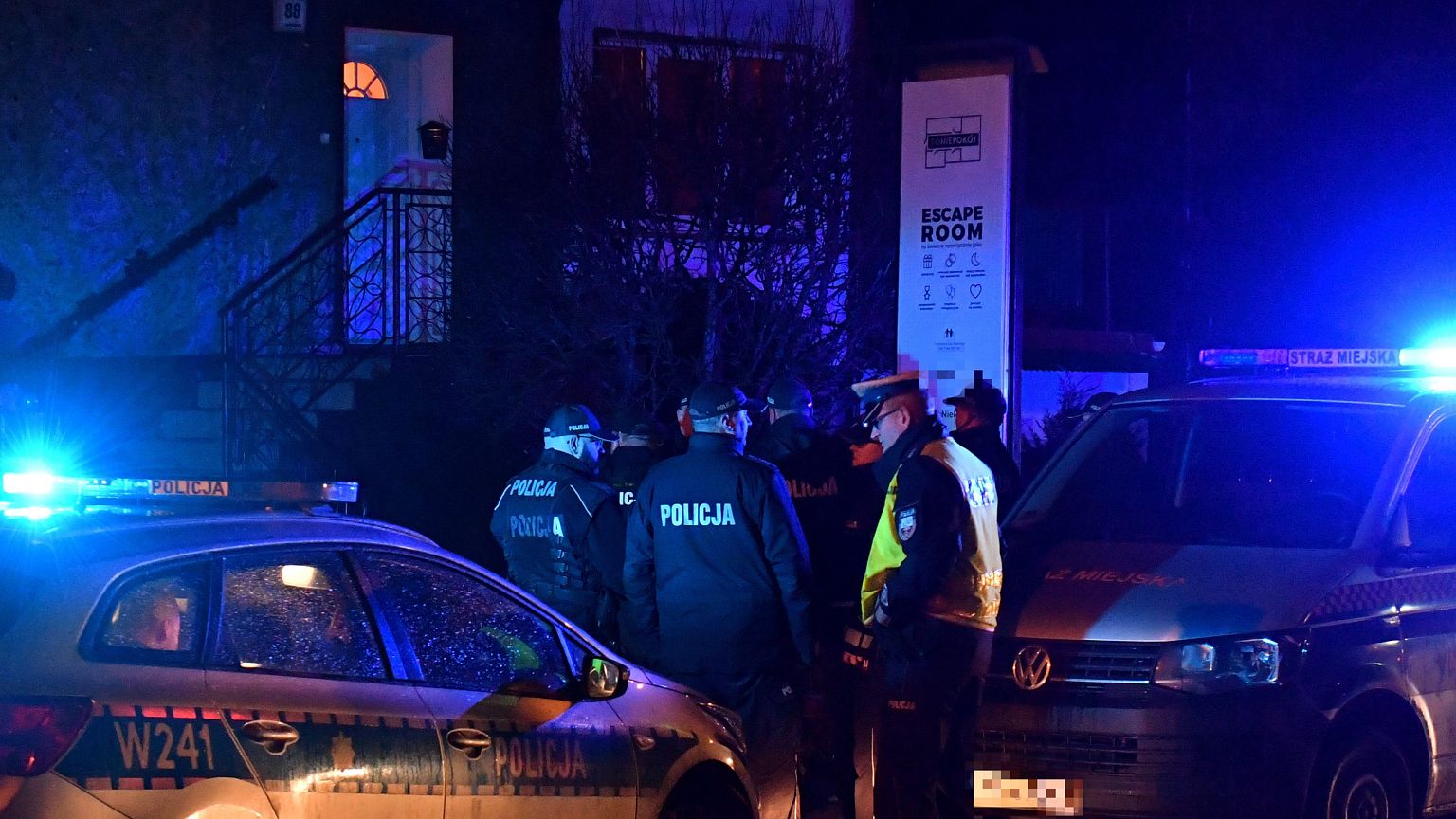 Image: Police secure the scene of a fire in an "escape room" that killed fi