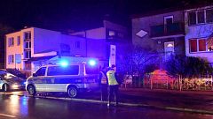 Image: FPolice secure the scene of a fire in an "escape room" that killed f