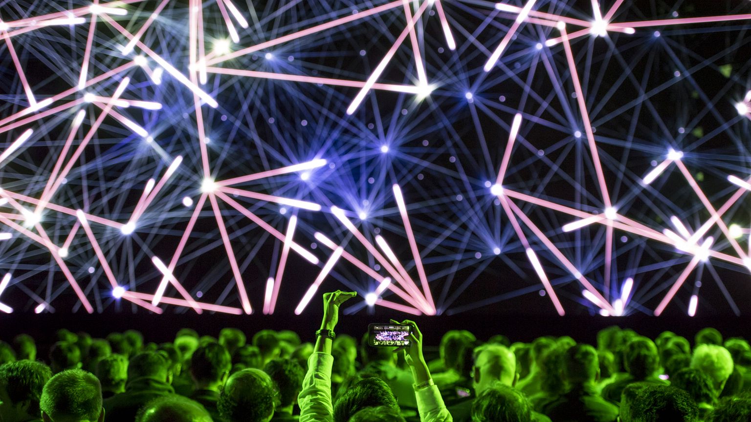 Image: An attendee takes a photograph before the Nvidia Corp. event at the 