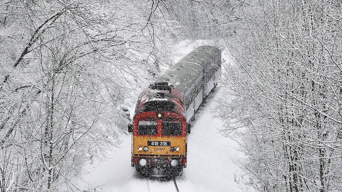 Image: A train crosses the Cuha Valley during heavy snowfall near Vinnye, H