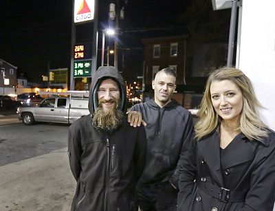 Johnny Bobbitt Jr., left, Kate McClure, right, and McClure\'s boyfriend Mark D\'Amico at a Citgo gas station in Philadelphia on Nov. 17, 2017.  McClure and D\'Amico raised more than $400,000 for Bobbitt Jr., a homeless man after he used his last $20 to fill up the gas tank of a stranded motorist in Philadelphia.