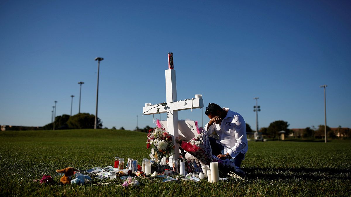 Image: Joe Zevuloni mourns at a memorial for the victims of a shooting at M