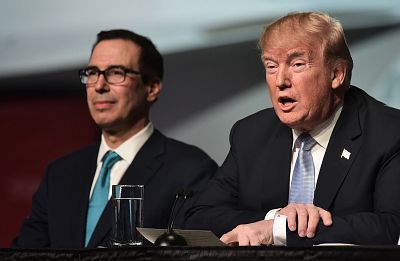 President Donald Trump speaks as Secretary of the Treasury Steven Mnuchin looks on during a tour of the Boeing Company on March 14, 2018 in St. Louis, Missouri.