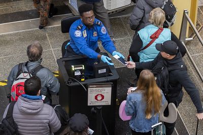 A TSA agent checks identification at Ronald Reagan Washington National Airport on Jan. 7.