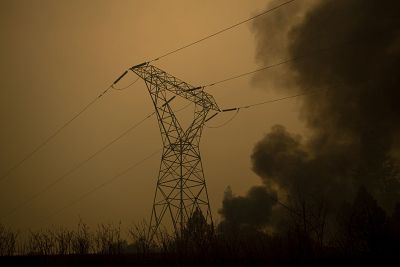 Smoke billows around power transmission lines as the Camp Fire burns in Big Bend, California, on Nov. 9, 2018.