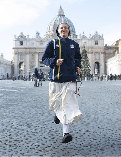 Marie-Theo Manaudpose, who is a nun and member of the Vatican athletics team, runs in front of St. Peter\'s Basilica on Thursday.