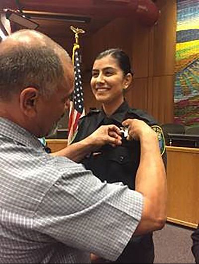 Natalie Corona is sworn in the Davis Police Department by her father, Merced, on Aug. 2, 2018.