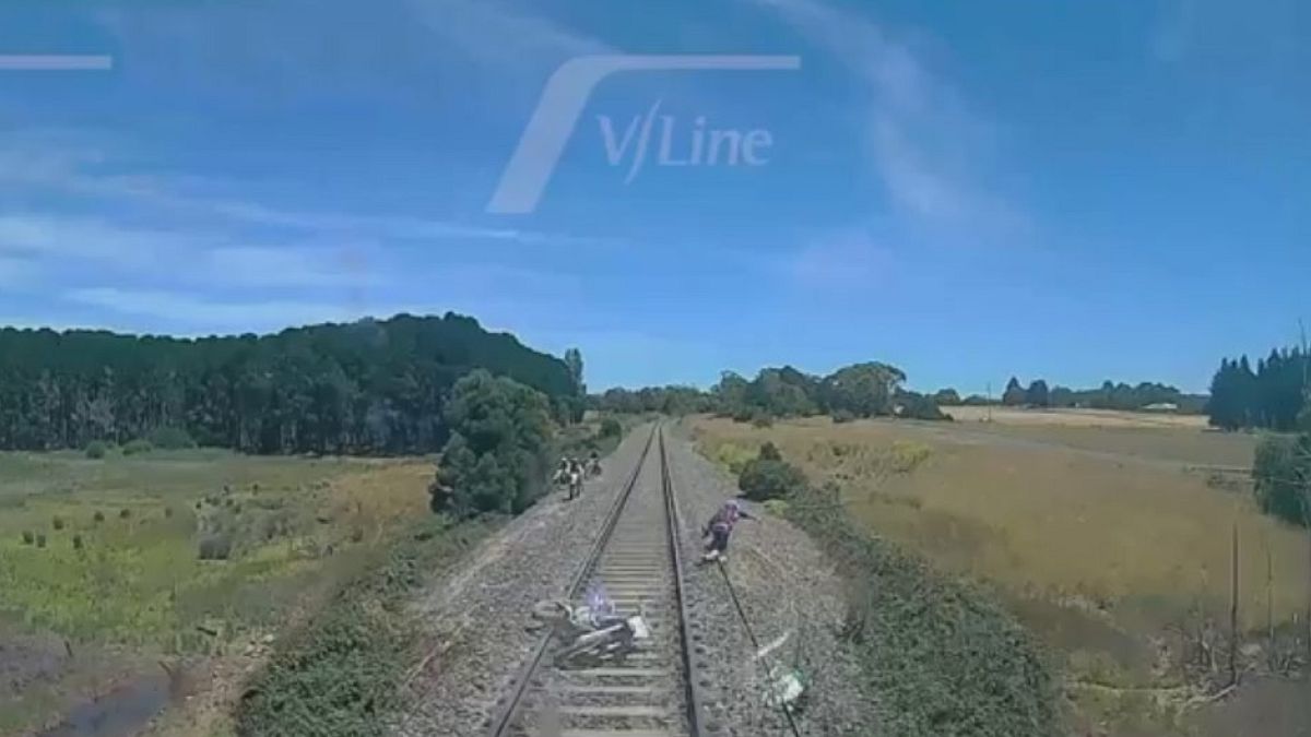 Watch: Biker's last-second leap from path of onrushing train