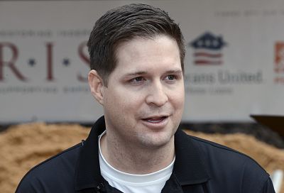 Retired U.S. Air Force Sr. Airman Brian Kolfage speaks to reporters during a 2016 groundbreaking ceremony for a new home he and his family were receiving through the Gary Sinise Foundation\'s RISE program at Sandestin, Florida, on Jan. 14, 2016.